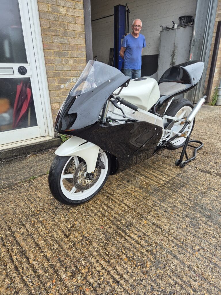 Sleek black and white sport motorcycle parked on a driveway.