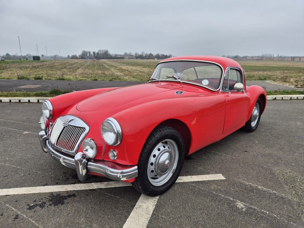 Red vintage car parked in open area.